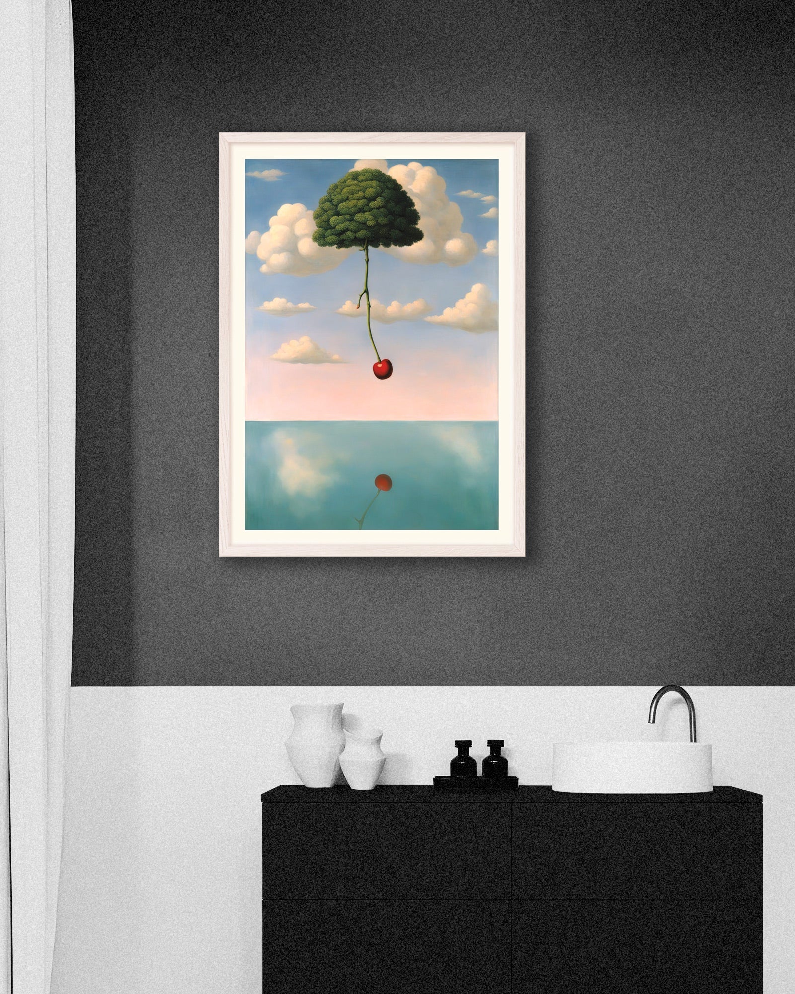 Bathroom with a dark gray wall and a framed surreal poster of a tree floating in the sky with a red cherry, above a black vanity
